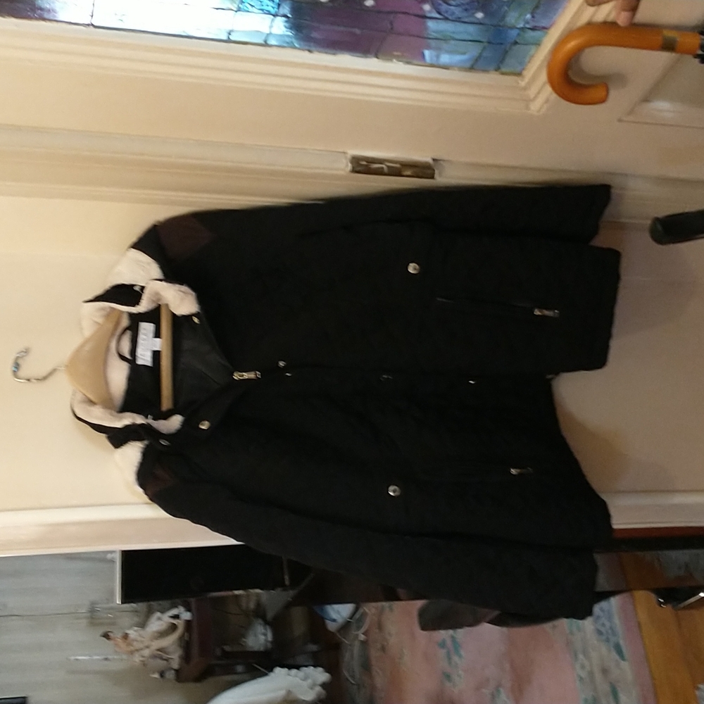 Black jacket with shearling inside and hood lined with shearling.